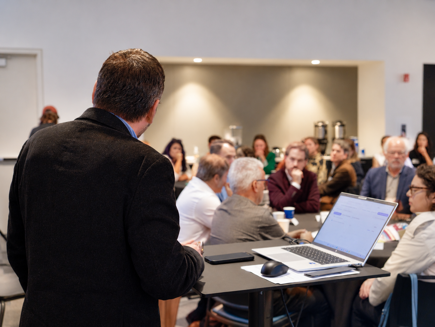 Presenter Addressing a Blurred Conference Audience